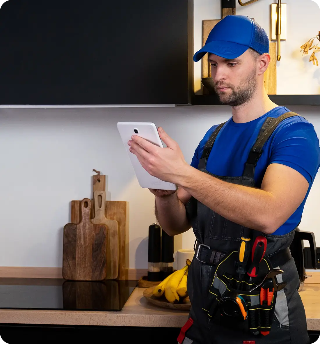B and Z Heating and Air HVAC technician reviewing service details on a tablet in a client's home
