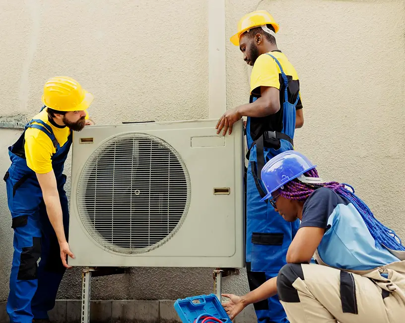 B and Z Heating & Air Conditioning Professional HVAC installation team working on outdoor air conditioning unit