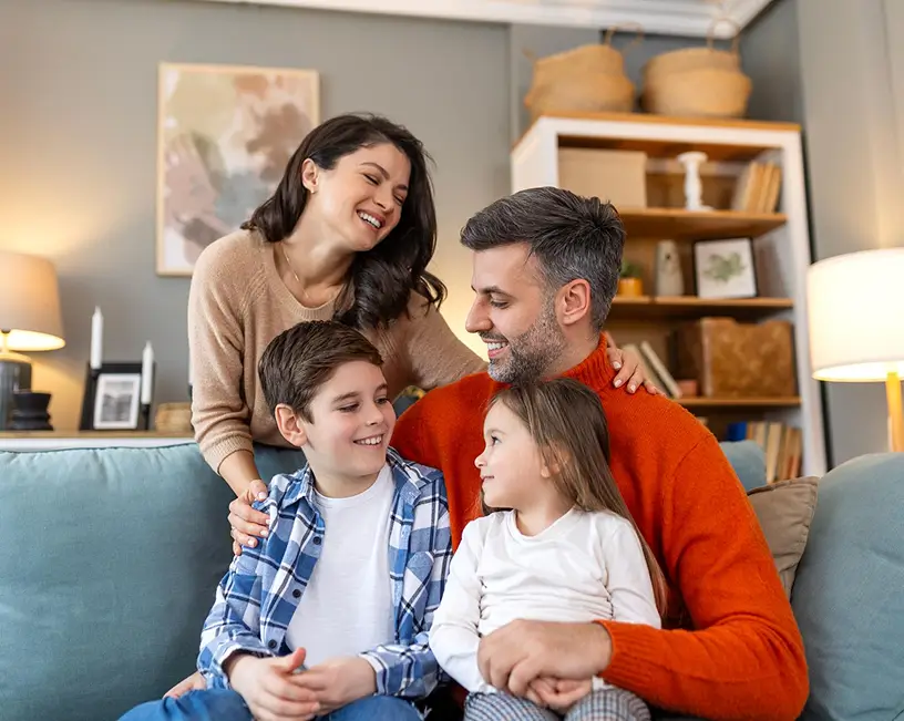 Happy family relaxing in a comfortable, climate-controlled living room