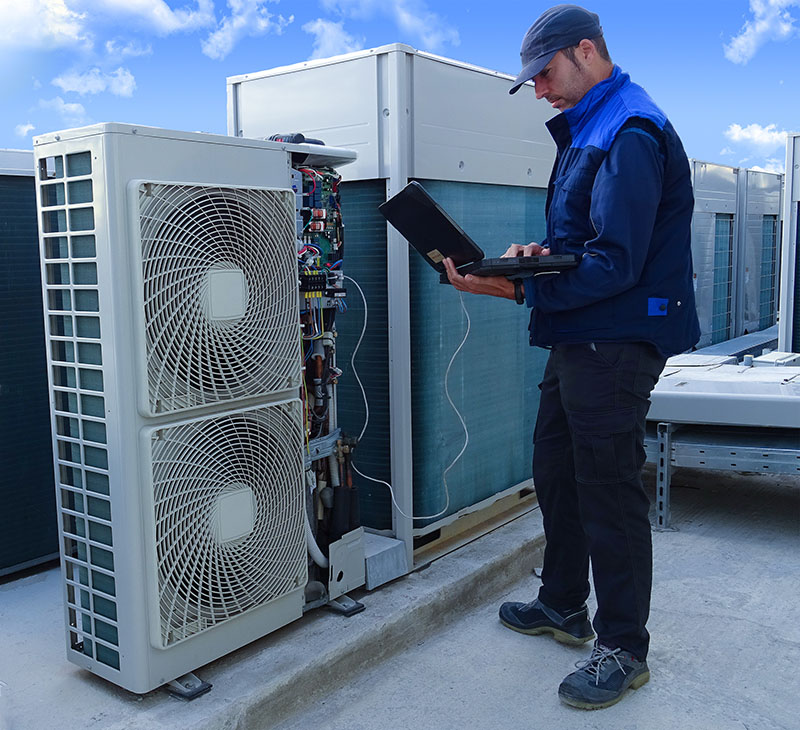 B&Z HVAC technician servicing an AC unit